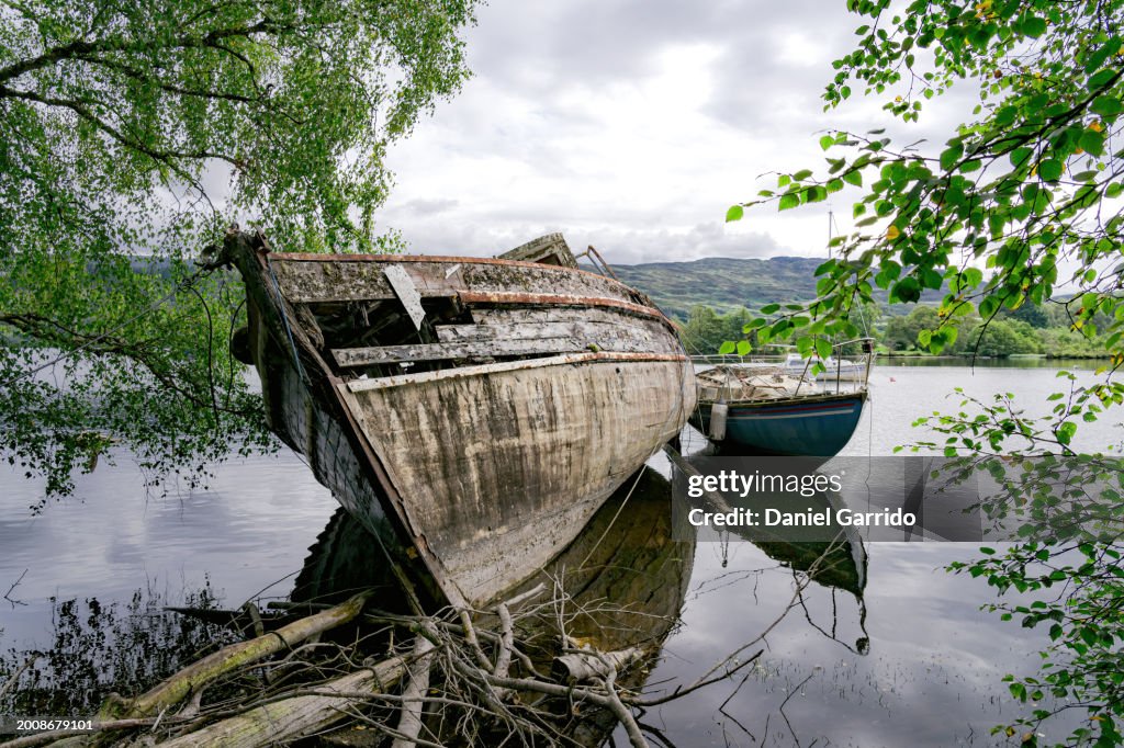 Ship stranded and wrecked in the lake, abandoned wreckage, ruined vessel.
