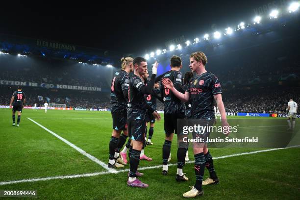 Phil Foden of Manchester City celebrates with Kevin De Bruyne of Manchester City after scoring his team's third goal during the UEFA Champions League...