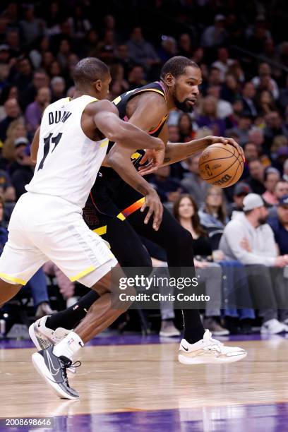 Kevin Durant of the Phoenix Suns posts up on Kris Dunn of the Utah Jazz during the game at Footprint Center on February 08, 2024 in Phoenix, Arizona....
