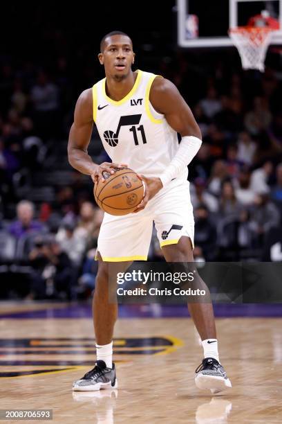 Kris Dunn of the Utah Jazz controls the ball during the game against the Phoenix Suns at Footprint Center on February 08, 2024 in Phoenix, Arizona....