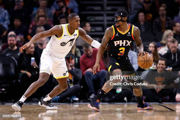 Bradley Beal of the Phoenix Suns posts up on Kris Dunn of the Utah Jazz during the game at Footprint Center on February 08, 2024 in Phoenix, Arizona....