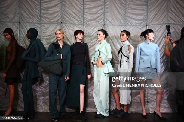 Models pose back-stage ahead of the catwalk presentation by Fashion East for their Autumn/Winter 2024 collection, during London Fashion Week in...