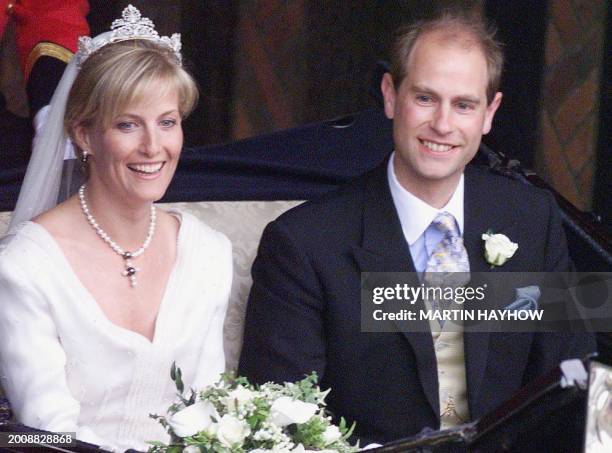 Sophie Rhys-Jones along with her husband Prince Edward smile to the crowd as they leave in an open carriage following their wedding at St. George's...