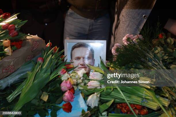 People lay flowers during a vigil for Alexiei Navalny in front of the Russian Consulate General on February 16, 2024 in Munich, Germany. The death of...