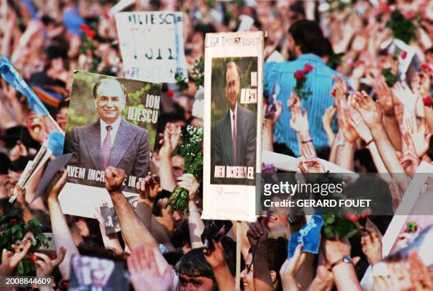 Supporters of National Salvation Front candidate and interim President Ion Iliescu shout slogans and wawe banners during Iliescu's final campaign...