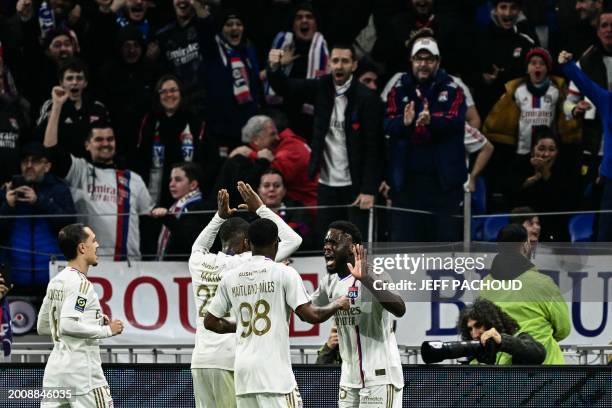 Lyon's Belgian midfielder Orel Mangala celebrates with teammates after scoring his team's first goal during the French L1 football match between...