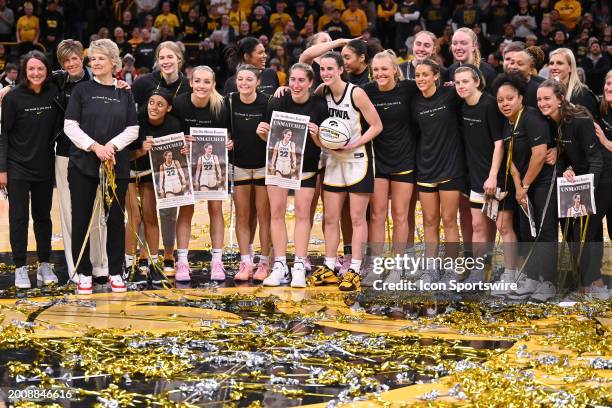 The Iowa women's basketball team poses for a group shot after Iowa guard Caitlin Clark broke the NCAA individual career scoring record during a...