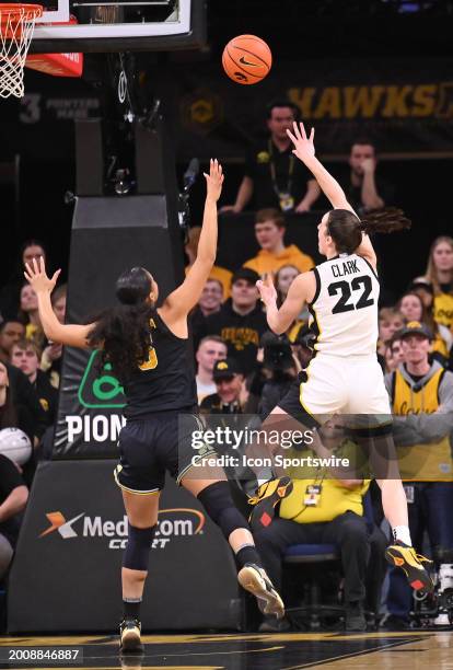 Iowa guard Caitlin Clark scores the first two points of the game during a women's college basketball game between the Michigan Wolverines and the...