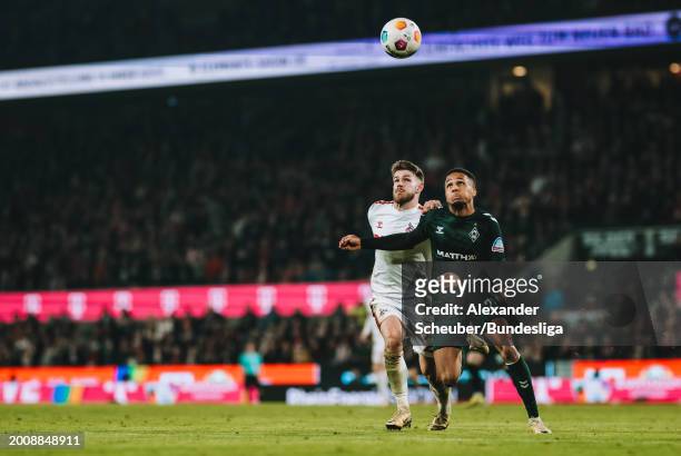 Jan Thielmann of Köln in action against Felix Agu of Bremen during the Bundesliga match between 1. FC Köln and SV Werder Bremen at...
