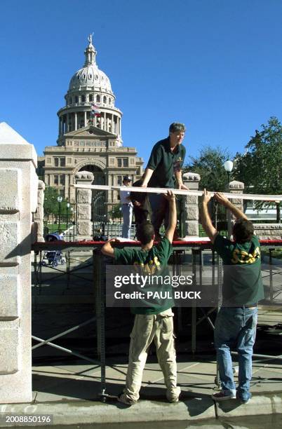 Crew workers from the George W. Bush campaign set up the stage with the Texas Capitol Building in the background 06 November, 2000 in Austin, Texas....