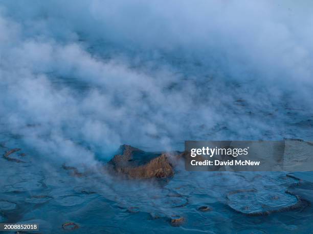 In an aerial view, steam rises from fumaroles, or steam vents, situated between two of the five Salton Buttes lava dome volcanoes that line the...