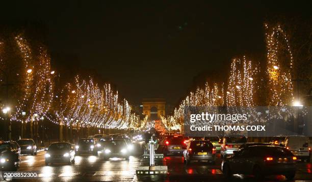 View of the Champs-Elysees Christmas illuminations, taken 28 November 2006 in Paris. Paris Mayor Bertrand Delanoe and French singer Florent Pagny...