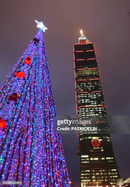 Five-storey high Christmas tree is seen nearby Taipei 101, the world's tallest skyscraper, 24 December 2007. AFP PHOTO/PATRICK LIN