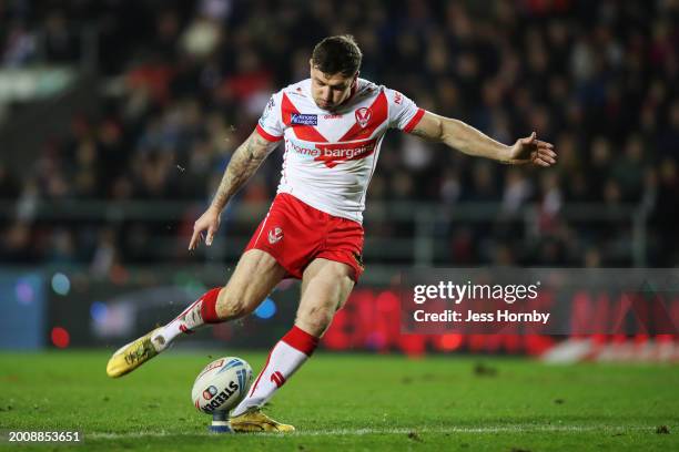 Mark Percival of St.Helens kicks a conversion after teammate Lewis Dodd scores his team's first try during the Betfred Super League match between St...