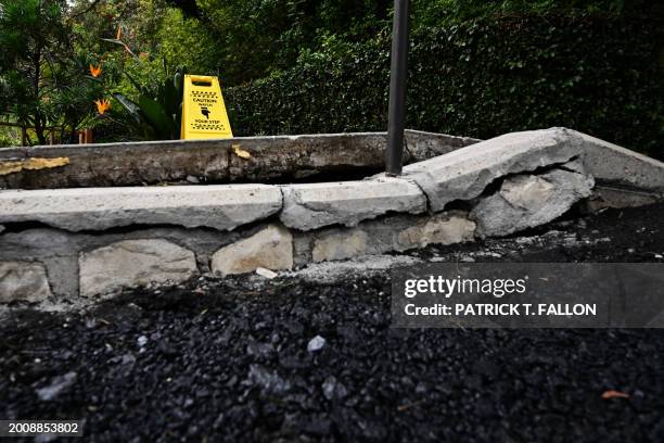 Cracked sidewalk and roadway outside the Wayfarers Chapel in a landslide prone area following its closure due to land movement after heavy rains in...