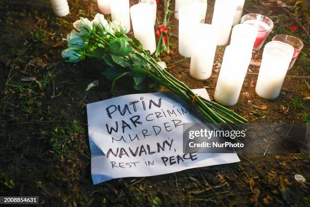 Flowers and candles are seen during a vigil for Alexiei Navalny in front of the Russian Consulate General in Krakow, Poland on February 16, 2024....