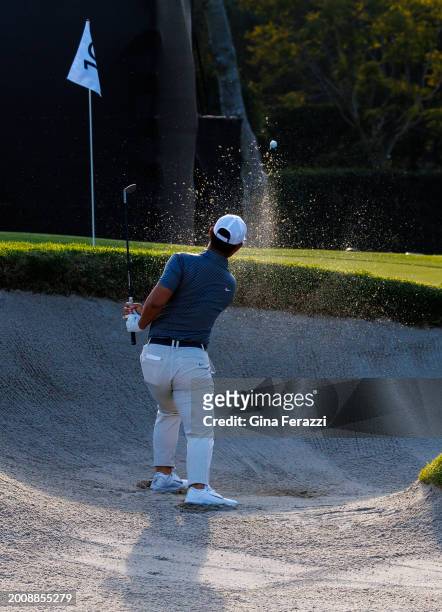 Tom Kim hits out of a green side bunker on hole 14 during the second round of the Genesis Invitational at Riviera Country Club on February 16, 2024...