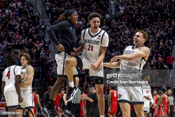 San Diego State guard BJ Davis celebrates with guard Miles Byrd and forward Elijah Saunders in the first half of a college basketball game between...