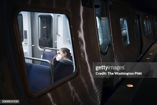 Passenger wears a mask while riding a train passing through the Metro Center station on Thursday January 04, 2024 in Washington, DC. There is...