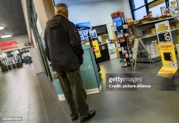 Photopost Shop A man stands in front of a post store in a supermarket. Photo: Markus ...