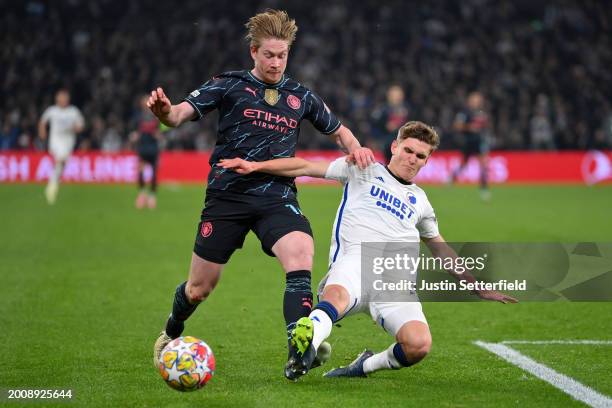 Kevin De Bruyne of Manchester City is tackled by Elias Jelert of FC Copenhagen during the UEFA Champions League 2023/24 round of 16 first leg match...
