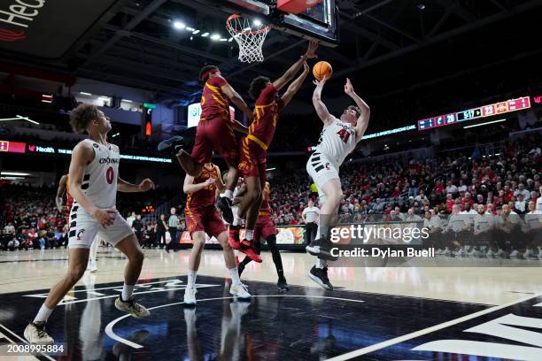 Simas Lukošius of the Cincinnati Bearcats while being guarded by Curtis Jones of the Iowa State Cyclones in the first half at Fifth Third Arena on...