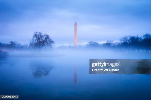 washington monument in the mist - washington monument dc stock pictures, royalty-free photos & images