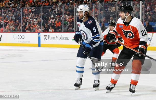 Alex Iafalio of the Winnipeg Jets skates against Scott Laughton of the Philadelphia Flyers at the Wells Fargo Center on February 8, 2024 in...