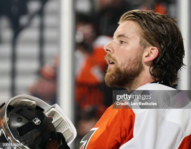 Samuel Ersson of the Philadelphia Flyers takes his goaltending mask off during a stoppage in play against the Winnipeg Jets at the Wells Fargo Center...