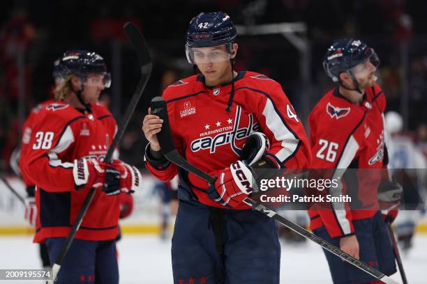 Martin Fehervary of the Washington Capitals and teammates react after losing the Colorado Avalanche at Capital One Arena on February 13, 2024 in...