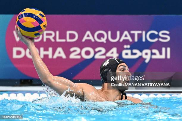 France's Alexandre Bouet throws the ball during the men's bronze medal water polo match between Spain and France at the 2024 World Aquatics...