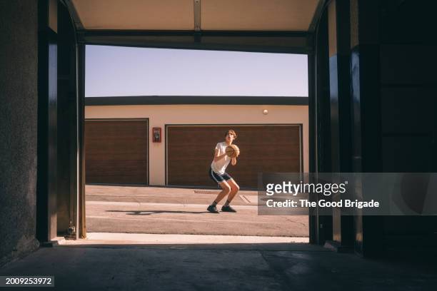 full length of teenager playing basketball on sunny day - malibu home stock pictures, royalty-free photos & images
