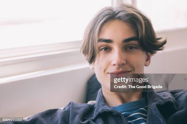 portrait of smiling teenage boy at home - malibu home stock pictures, royalty-free photos & images