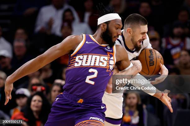 Alex Len of the Sacramento Kings steals the ball from Josh Okogie of the Phoenix Suns during the first half at Footprint Center on February 13, 2024...