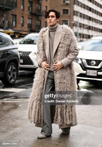 Chase Hudson is seen wearing a Michael Kors faux fur coat vest, gray sweater, gray pants outside the Michael Kors show during NYFW F/W 2024 on...
