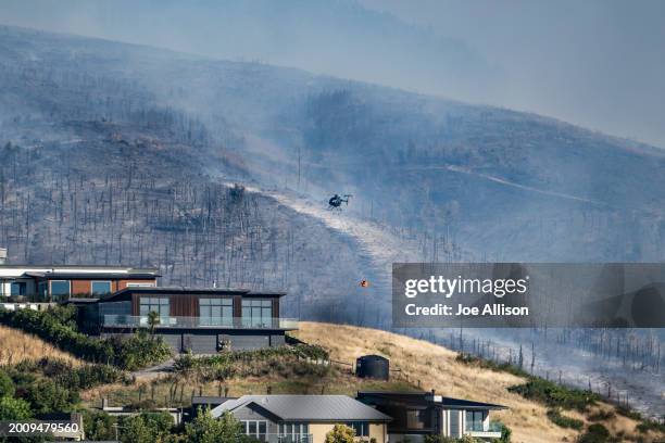 Helicopter works on extinguishing the fire on February 14, 2024 in Christchurch, New Zealand. Residents were evacuated as fire fighters battled a...