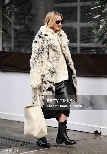 Lisa Aiken is seen wearing a black and white faux fur coat, cream top, black skirt and black boots with black sunglasses outside the Michael Kors...