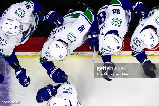 Nikita Zadorov of the Vancouver Canucks, Sam Lafferty, and Nils Aman on bench during the third period of the game against the Carolina Hurricanes at...