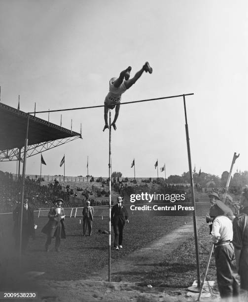 American athlete Lee Barnes, clears the bar, watched by officials, as he completes his winning vault in the final of the men's pole vault event of...