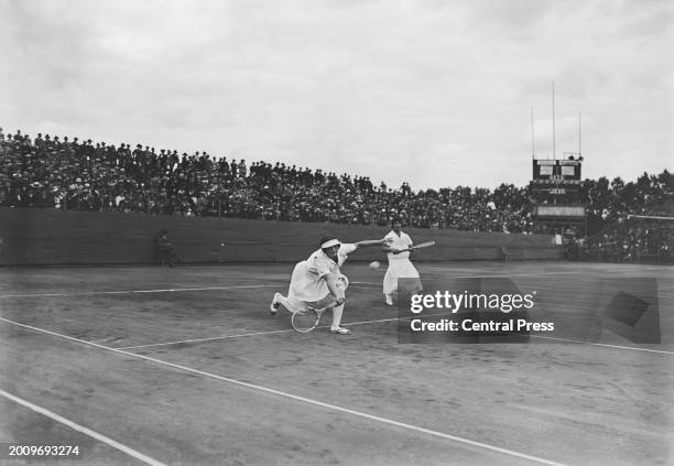 American tennis player Hazel Wightman and American tennis player Helen Wills on the tennis court during the final of the women's doubles tennis event...