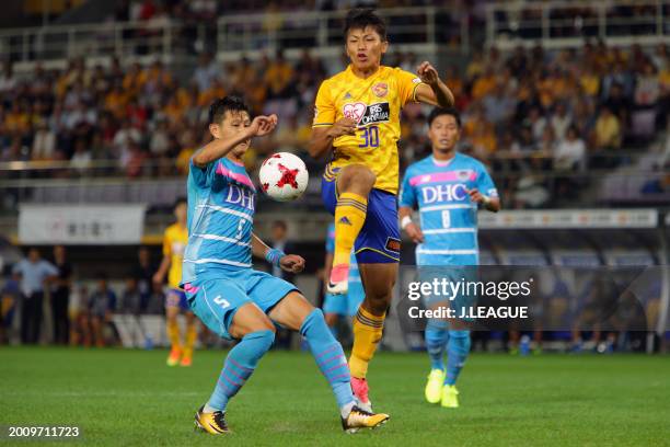 Takuma Nishimura of Vegalta Sendai controls the ball against Kim Min-hyeok of Sagan Tosu during the J.League J1 match between Vegalta Sendai and...