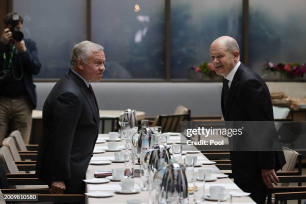 German Chancellor Olaf Scholz and King Abdullah II of Jordan take their seats during bilateral talks at the 'Bayerischer Hof' hotel, the venue of the...