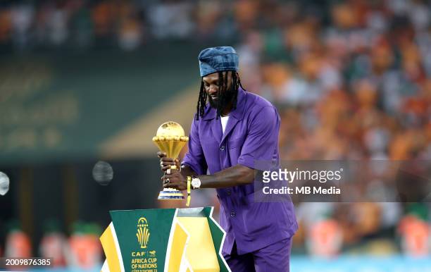 Former Togolese´player Emmanuel Adebayor carries the Africa Cup of Nations trophy to the podium after Ivory Coast won the Africa Cup of Nations 2024...