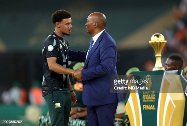 South Africa's goalkeeper Ronwen Williams greets President of the Confederation of African Football Patrice Motsepe after receiving the Golden Glove...
