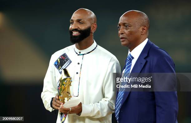 Equatorial Guinea's Emilio Nsue holds the best player award as he stands next to President of the Confederation of African Football Patrice Motsepe...