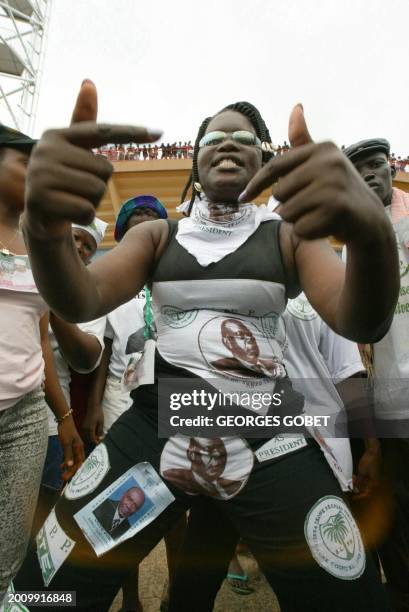 Supporter of Sierra Leone's President and presidential candidate of the ruling Sierra Leone People Party Ahmad Tejan Kabbah, wearing clothes bearing...