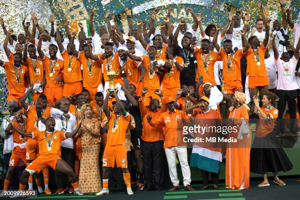 Ivory Coast's forward Max-Alain Gradel lifts the Africa Cup of Nations trophy on the podium after Ivory Coast won the Africa Cup of Nations 2024...