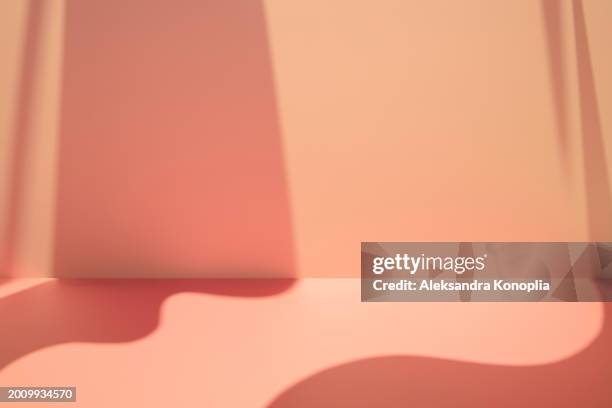 empty studio 3d exhibition background - peach pink, pastel beige stage with soft natural abstract diagonal wavy shadows, architectural window light. front view, copy space. - fokus-auf-den-hintergrund stock-fotos und bilder
