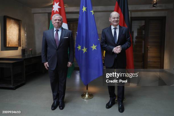 German Chancellor Olaf Scholz and King Abdullah II of Jordan pose for the media during bilateral talks at the 'Bayerischer Hof' hotel, the venue of...