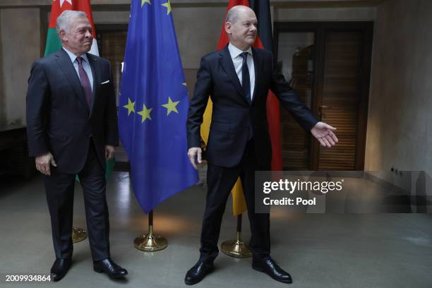 German Chancellor Olaf Scholz and King Abdullah II of Jordan pose for the media during bilateral talks at the 'Bayerischer Hof' hotel, the venue of...